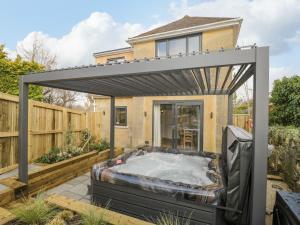 a hot tub in the backyard of a house at Birch House in Corsham