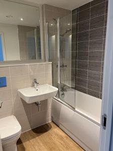 a bathroom with a sink and a shower and a toilet at Brand new heart of Birmingham one bedroom in Birmingham