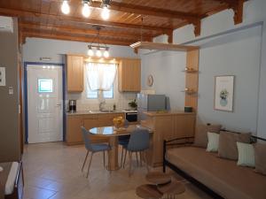 a living room and kitchen with a table and a couch at Katerina house in Finikounta
