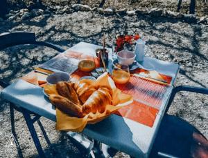 a picnic table with a loaf of bread on it at Lodg'ing Nature Camp Luberon in Saint-Michel-lʼObservatoire