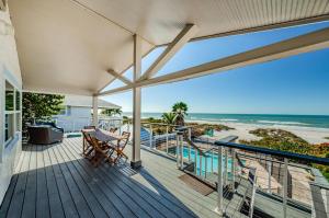 a balcony with a table and a view of the beach at Sunshine's Hideaway in Clearwater Beach