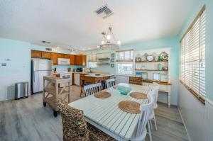 a kitchen and dining room with a table and chairs at Sunshine's Hideaway in Clearwater Beach