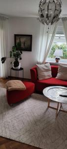 a living room with a red couch and a table at Apartment Lia in Beerfelden