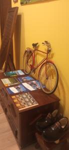 a bike parked on a table next to a wall at L'Antojana del Cuera Llanes Aptos in Covielles