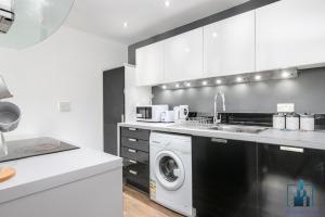 a kitchen with a washing machine and a washer at City View Apartments in Birmingham