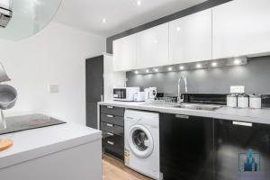 cocina con lavadora y lavadora en City View Apartments en Birmingham