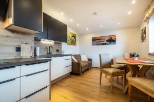 a kitchen with a table and a dining room at Appartement Jäger in Flachau