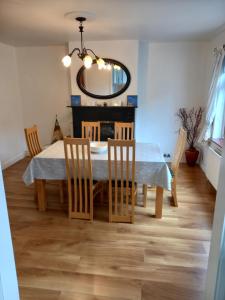 a dining room with a table and chairs and a mirror at 13 Pearse Tce. in Sligo