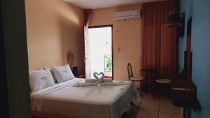 Cama ou camas em um quarto em Albacora Praia Hotel