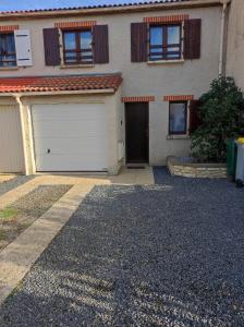 uma casa com duas portas de garagem e uma entrada em Une Parenthèse Enchantée em Saint-Sébastien-sur-Loire