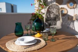 una mesa de madera con un plato y gafas. en D'olivo Home - Luxury Suite, en Bari