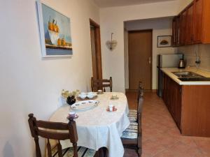 a kitchen with a table and chairs with a table and a kitchen at Villa Agava in Vrboska