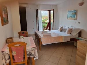 a bedroom with a bed and two tables and a window at Villa Agava in Vrboska