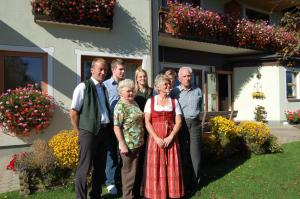 a group of people standing in front of a house at Hotel Gasthof zur Linde in Mariahof