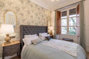 A bed or beds in a room at CH Elvira Luxury Apartment