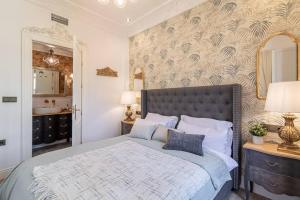 A bed or beds in a room at CH Elvira Luxury Apartment