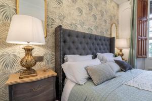 A bed or beds in a room at CH Elvira Luxury Apartment