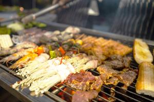 a grill with many different types of food on it at KNN Luxury Hill in Sen Monorom