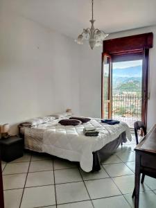 a bedroom with a bed and a table and a window at Appartamento Dimora dei marchi in Cosenza