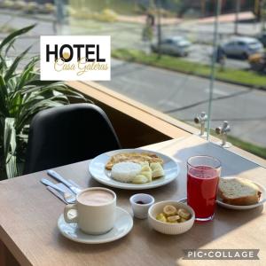 a table with two plates of food and a cup of coffee at Hotel Casa Galeras in Pasto