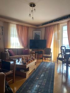 a living room with a couch and a table at Πηνελόπη Apartment 3-bed flat in Tripolis