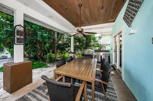 a patio with a wooden table and chairs at Sunset Splash in Clearwater Beach