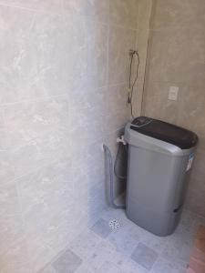 a bathroom with a trash can in the corner at Casa proximo a praia in Paulista