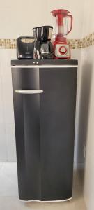 a black counter with a blender on top of it at Casa Sophia 17 ( Condomínio Aberto ) in Três Lagoas