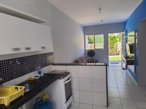 a kitchen with a sink and a stove at Casa proximo a praia in Paulista