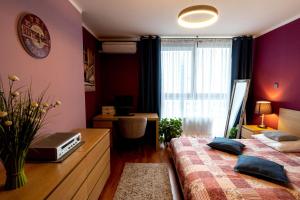 a bedroom with two beds and a desk and a window at Torre Verona Apartment - 70m2, Terrace in Kraków