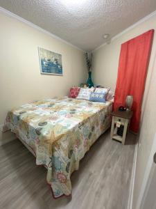 una camera con letto e tenda rossa di Sun Splashed Condo! Steps to Beach and 2 Pools Galveston Island a Galveston