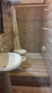 a bathroom with a sink and a toilet and a shower at Casa di Tony in Trapani