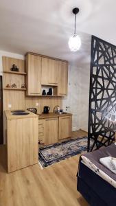 a kitchen with wooden cabinets and a counter top at Apartmani blue i green in Bugojno