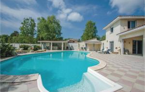 a swimming pool in the backyard of a house at Amazing Home In Saint-Vivien-De-Medoc in Saint-Vivien-de-Médoc