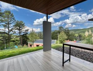 a view from the deck of a house with a table at Tres Vientos - Lofts de Montaña Raco in Raco