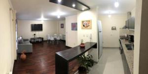 a room with a kitchen and a living room at Departamento Caseros Desings in Salta