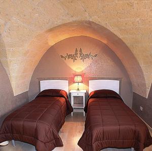 Un pat sau paturi într-o cameră la B&B Duca Orsini