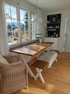 a dining room with a wooden table and chairs at Filipponi's Träumli in Rüthi