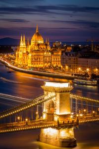 a view of a bridge with a city at night at Suzan's apartment in the heart of Budapest in Budapest