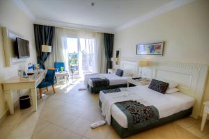 a hotel room with two beds and a desk at IL Mercato Hotel & Spa in Sharm El Sheikh