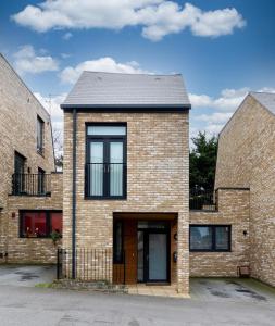 a brick house with a black roof at North London Suburbs in Barnet