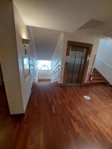 an empty room with a staircase and wooden floors at Hotel Villa Medici in Rocca San Giovanni