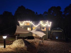 a tent in front of a house at night at The Mountain Camp at Mesilau, Kundasang by PrimaStay in Ranau