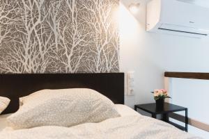 Un pat sau paturi într-o cameră la Central Private Lofts