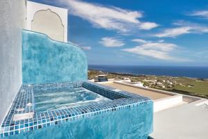 a hot tub on top of a building with the ocean at Nectarios Villa 2 in Fira