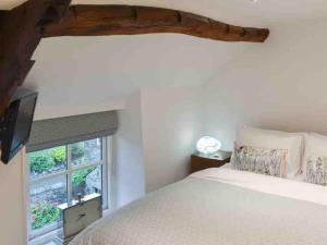 a bedroom with a bed and a window at No6, Queens square in Kirkby Lonsdale