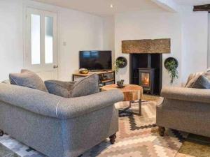 a living room with two couches and a fireplace at No6, Queens square in Kirkby Lonsdale