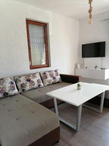 a living room with a couch and a table at Villa Apartments STEFAN - Ramne Ohrid in Ohrid