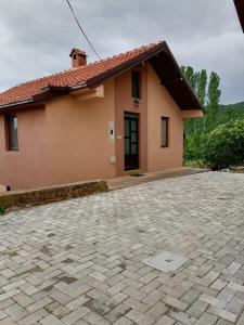 a house with a brick driveway in front of it at Villa Apartments STEFAN - Ramne Ohrid in Ohrid