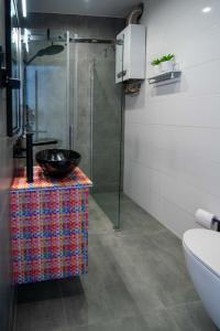 a bathroom with a sink and a glass shower at Glamour Apartment - w samym sercu miasta, nieopodal rynku in Katowice